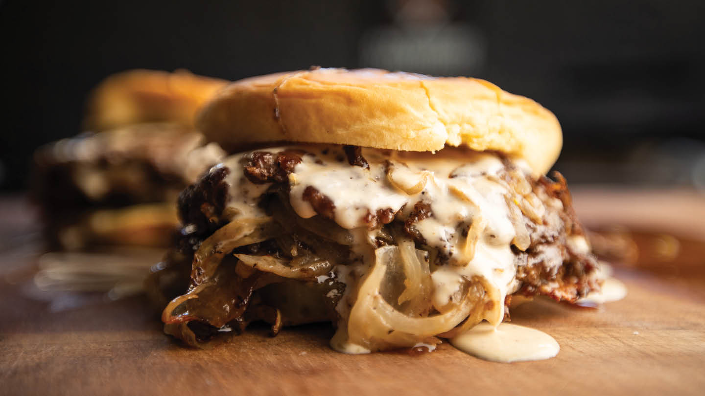 Alabama White Smash Burgers – finished burger with sauce drizzle