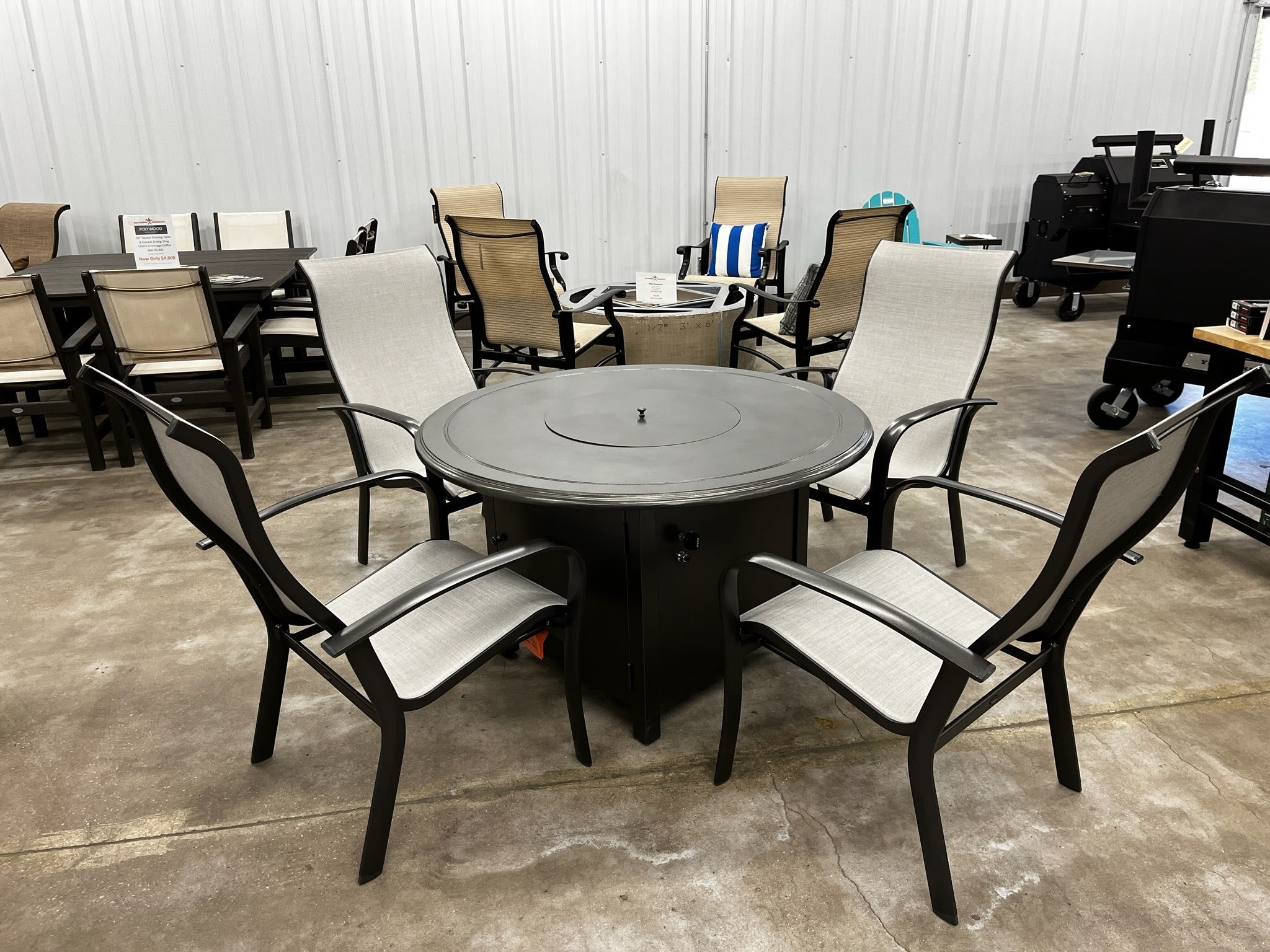 Local Special, Floor Model, Woodard 48" Beaded Edge Top Dining Fire Pit in Pewter with 4 Fremont Sling Dining Arm Chairs, SOLD AS IS, limited warranty 12044560